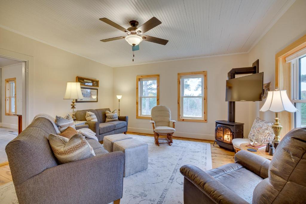 a living room with couches and a ceiling fan at Lovely Hixton Home with Porch and Fire Pit! in Black River Falls