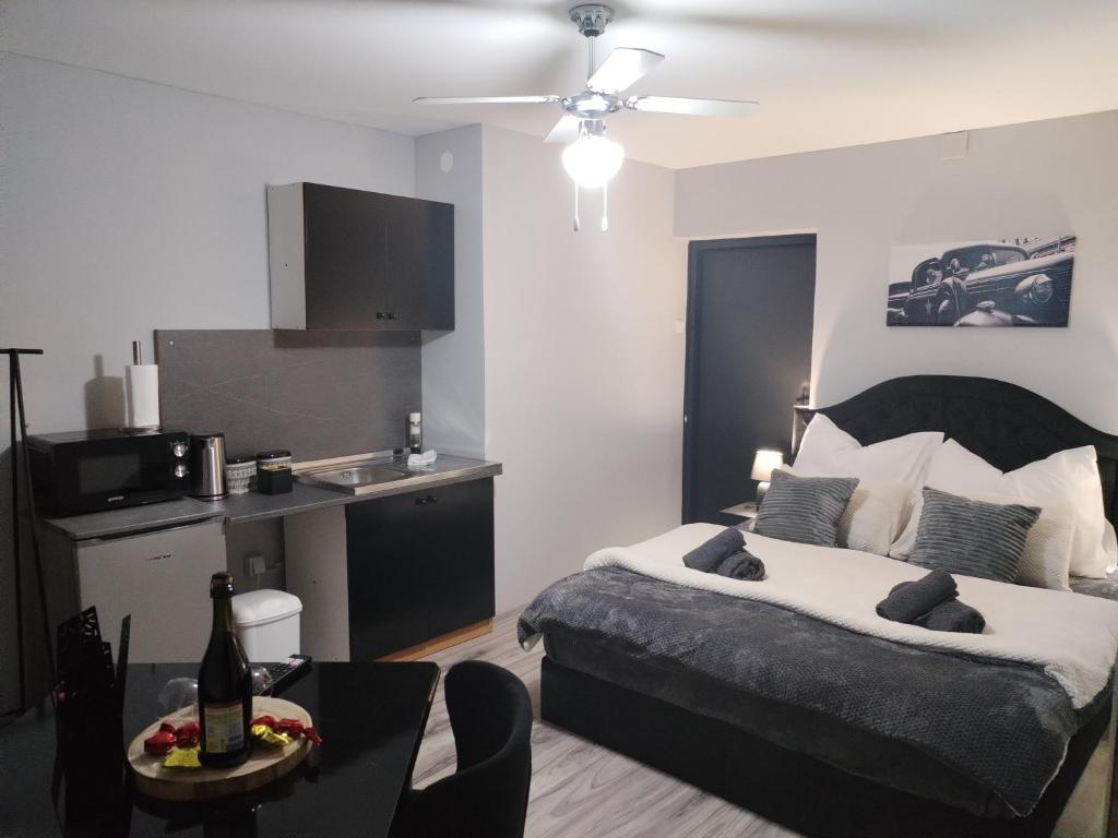 Cet appartement comprend une chambre avec un lit et une table ainsi qu'une cuisine. dans l'établissement Skitnica Red door, à Koprivnica