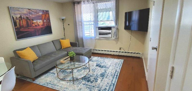 a living room with a couch and a table at Wonderful 3BR apartment in NYC! in New York
