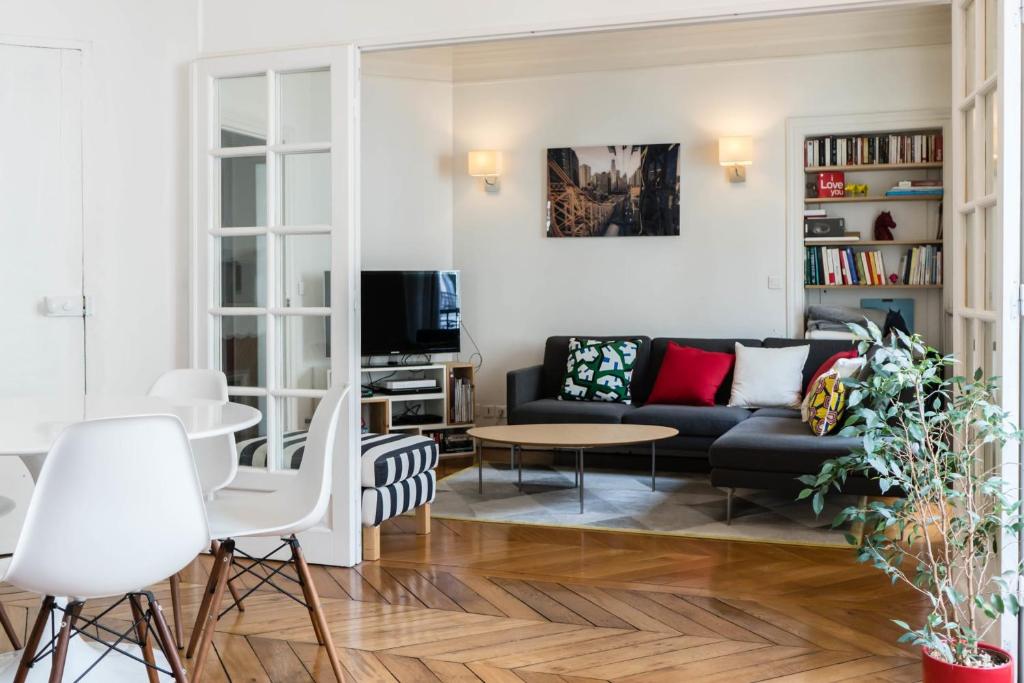 a living room with a couch and a table at Beautiful &amp; Bright Apartment Near Pigalle in Paris