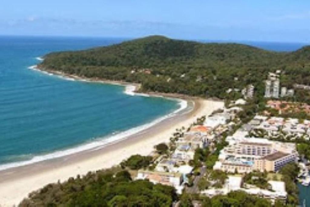 an aerial view of a beach next to the ocean at Absolute Hastings Street Noosa Suite in Noosa Heads