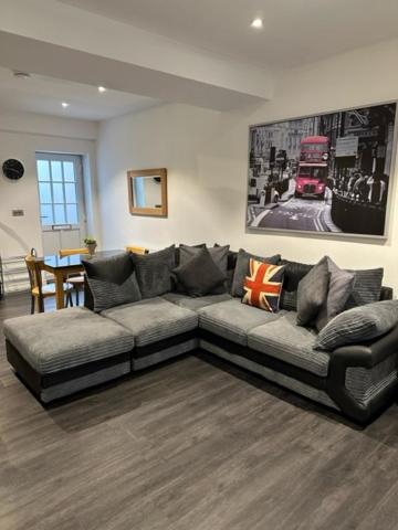 a living room with a couch and a table at Stunning Flat with Parking Free near Sutton Station in Cheam