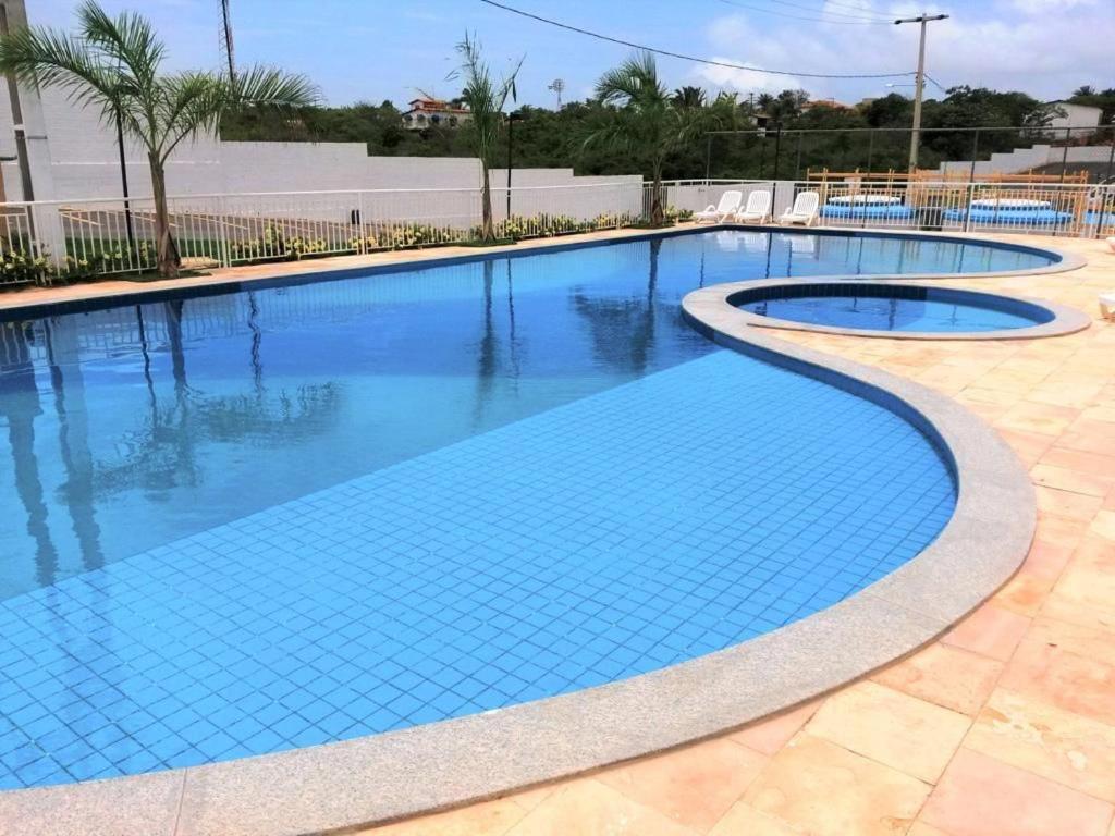 a large swimming pool with blue water at SUA ESTADIA PERFEITA in São Luís