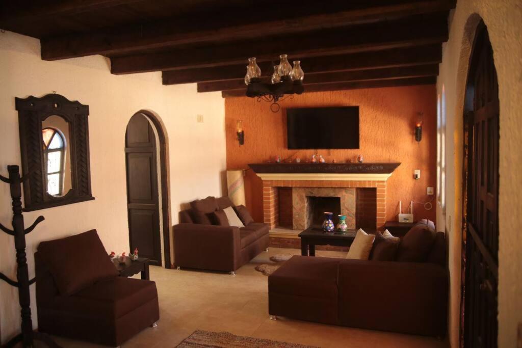 a living room with couches and a fireplace at Casa Fátima in San Cristóbal de Las Casas