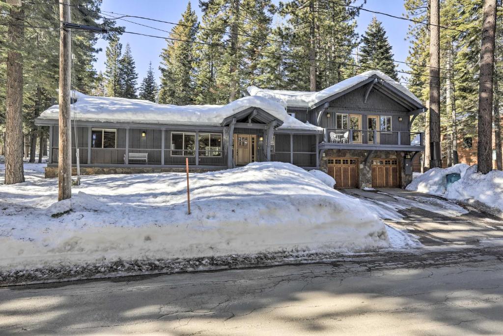 a house is covered in snow with a driveway at Bluerock Retreat - 3 BR West Shore Cabin - 3 Fireplaces, Short Drive to Skiing in Tahoe City