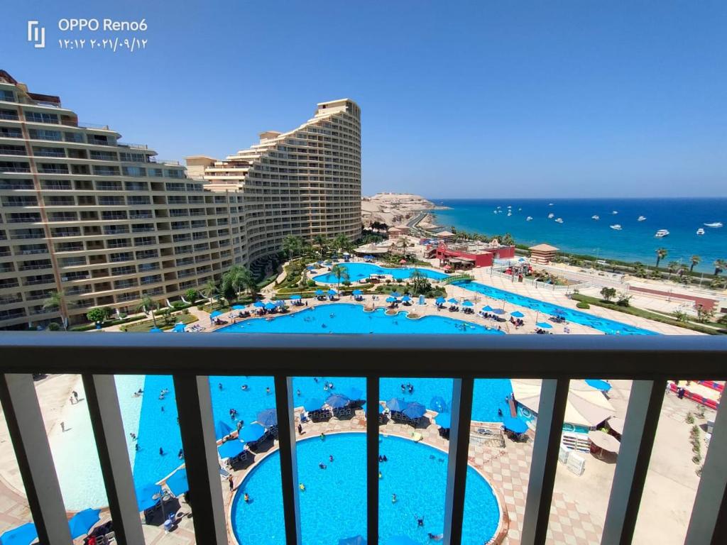 a view of the pool from the balcony of a resort at Porto sokhna pyramids family only in Ain Sokhna