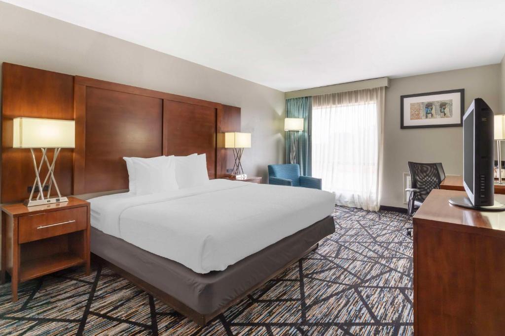 a hotel room with a bed and a flat screen tv at Best Western near Lackland AFB Sea World in San Antonio