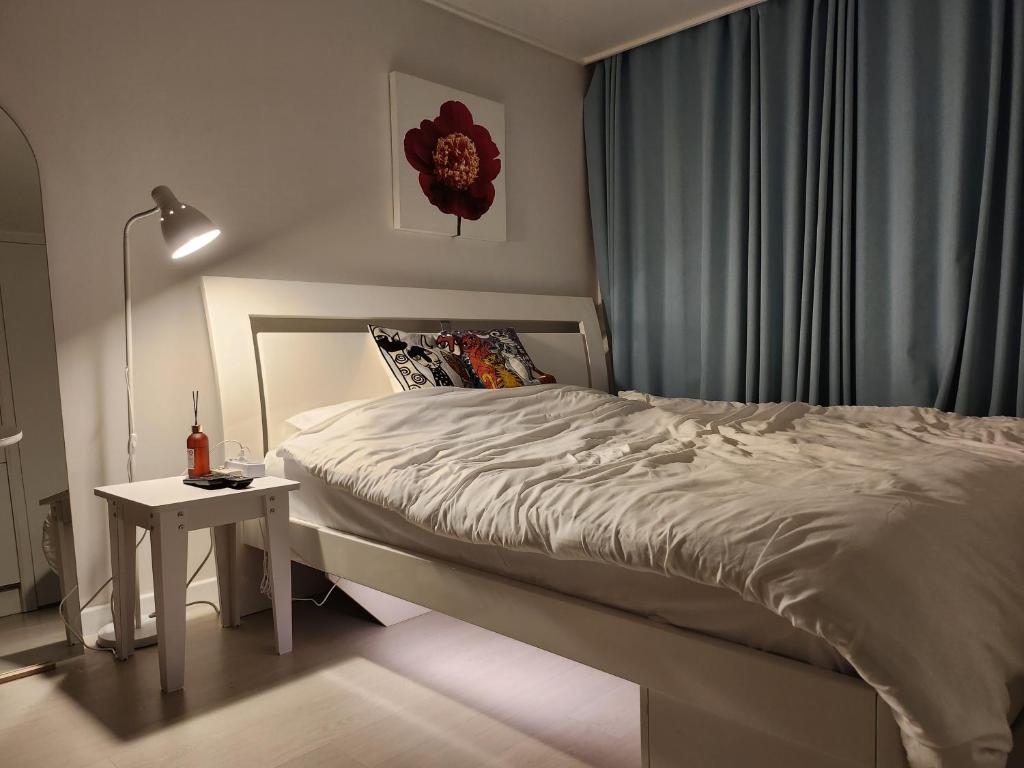Schlafzimmer mit einem Bett und einem Beistelltisch in der Unterkunft Welcome to Jejubi house in Jeju-do