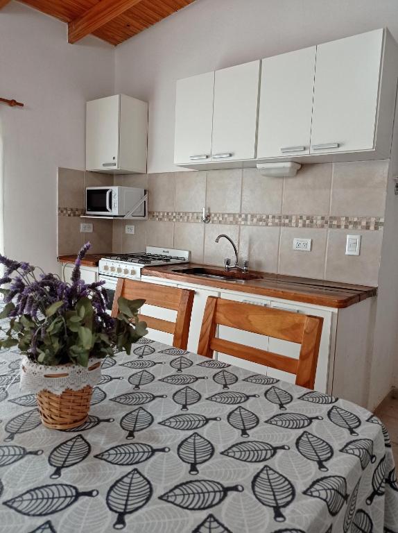 a kitchen with a table with a table cloth on it at Casa Ruca Lawen in Sierra de la Ventana