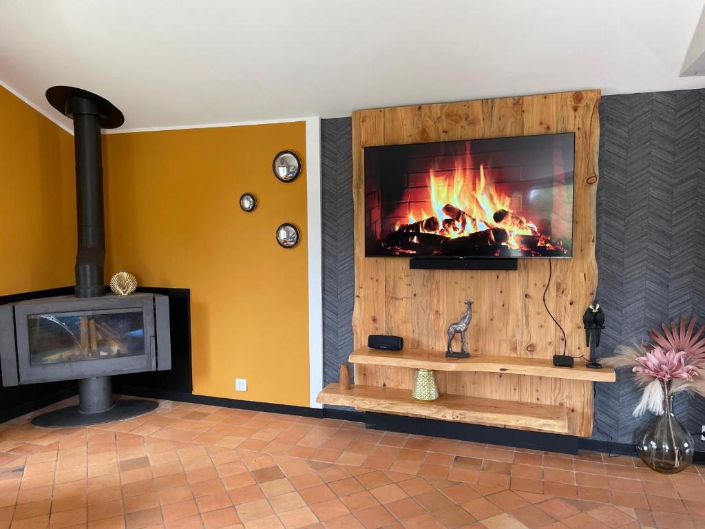 a fireplace in a living room with a fire at Gîte La Flèche, 4 pièces, 6 personnes - FR-1-410-424 in La Flèche