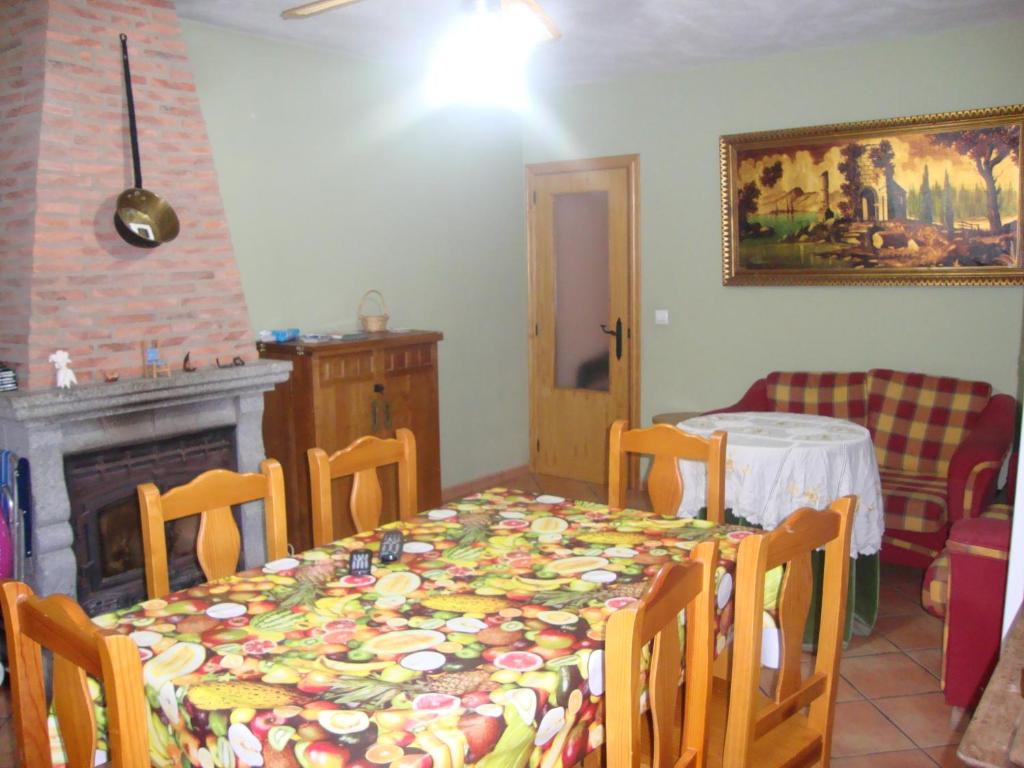 a dining room with a table and a fireplace at La Nature alojamiento natural in La Codosera