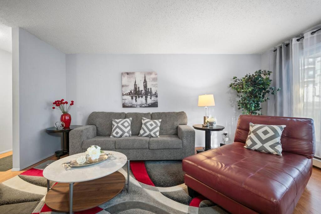 a living room with a couch and a table at CHIC 2BR Near Keyano College Free Parking in Fort McMurray