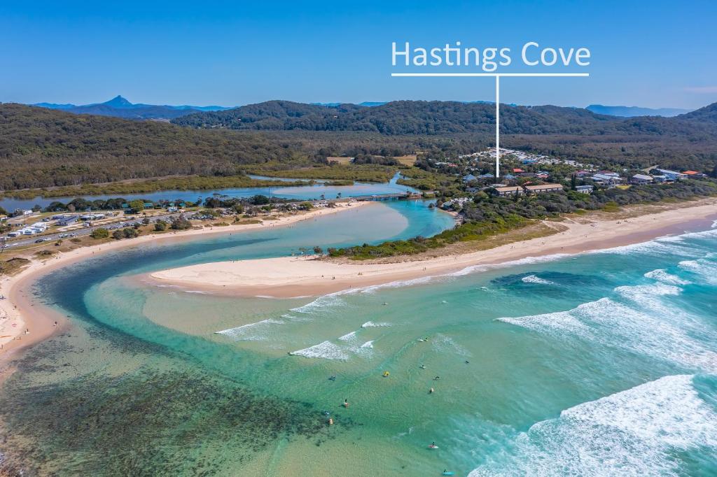 an overhead view of a beach with the wordships cove at Hastings Cove Holiday Apartments in Hastings Point