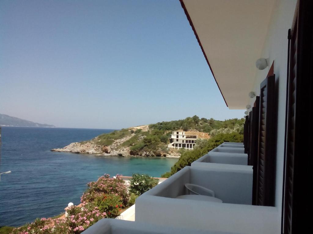 a view of the ocean from the balcony of a house at Hotel Bella Vista in Samos