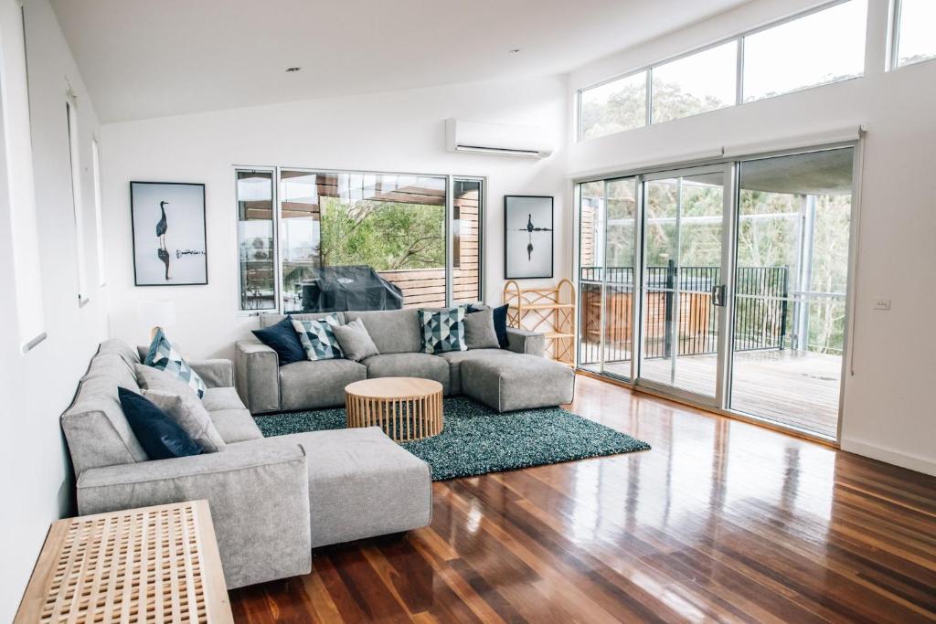 a living room with a couch and a table at River House - Wildlife at your doorstep in Kennett River