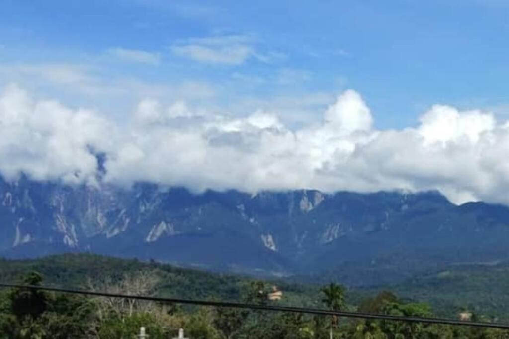 a view of a mountain range with clouds in the sky at Prima Homestay Ranau in Ranau