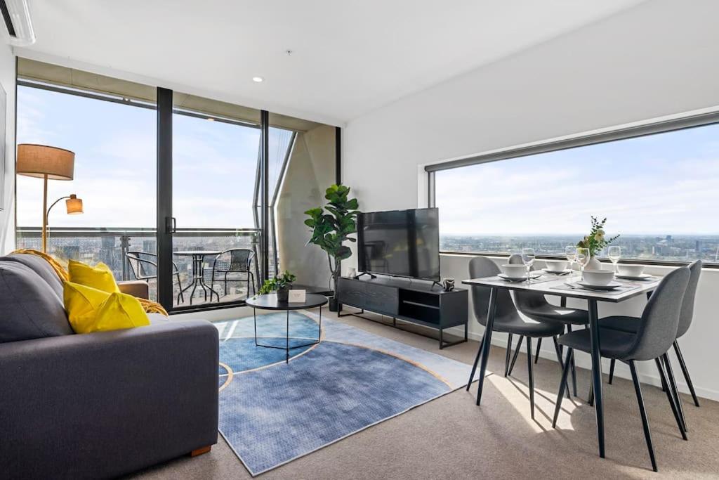 a living room with a couch and a table at Breathtaking View - 2BR Apt in Melbourne CBD w Gym in Melbourne