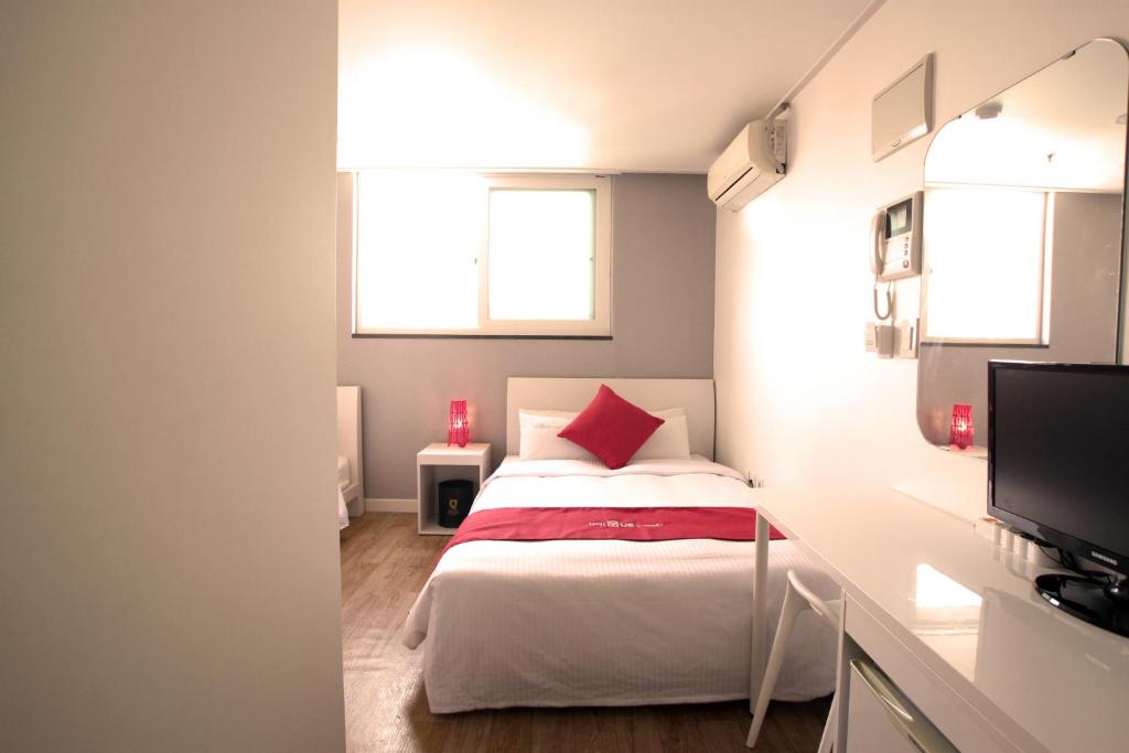 Postel nebo postele na pokoji v ubytování Jn Park Hotel Dongdaemun
