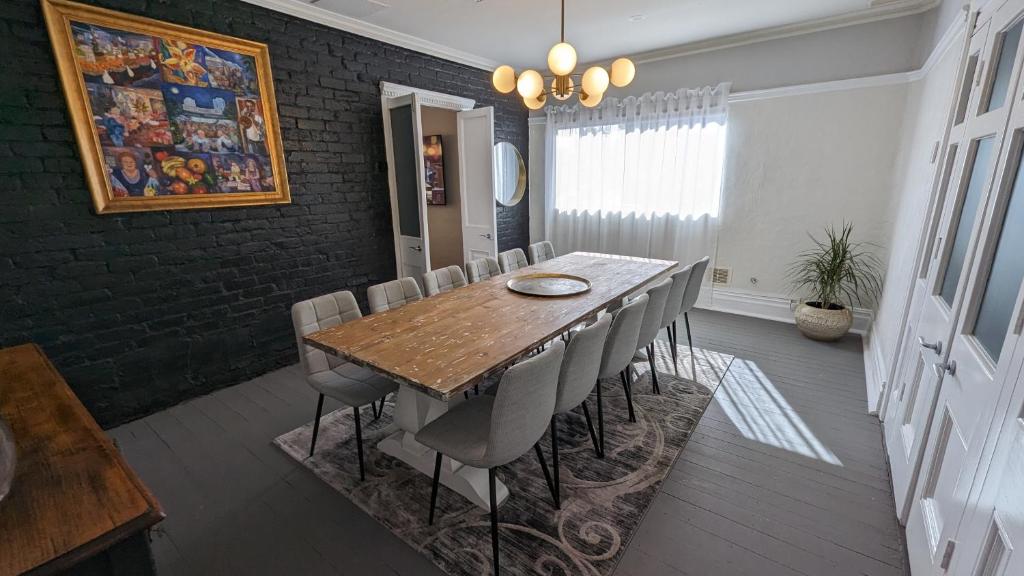 a dining room with a wooden table and chairs at Hatbox House in Perth