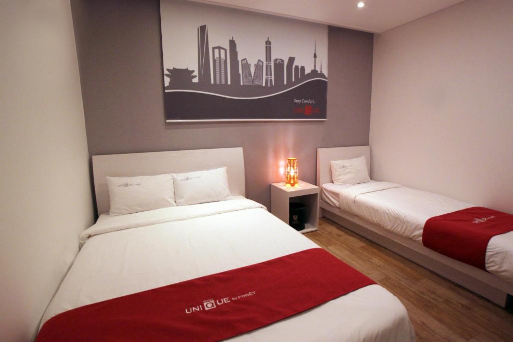 Postel nebo postele na pokoji v ubytování Jn Park Hotel Dongdaemun