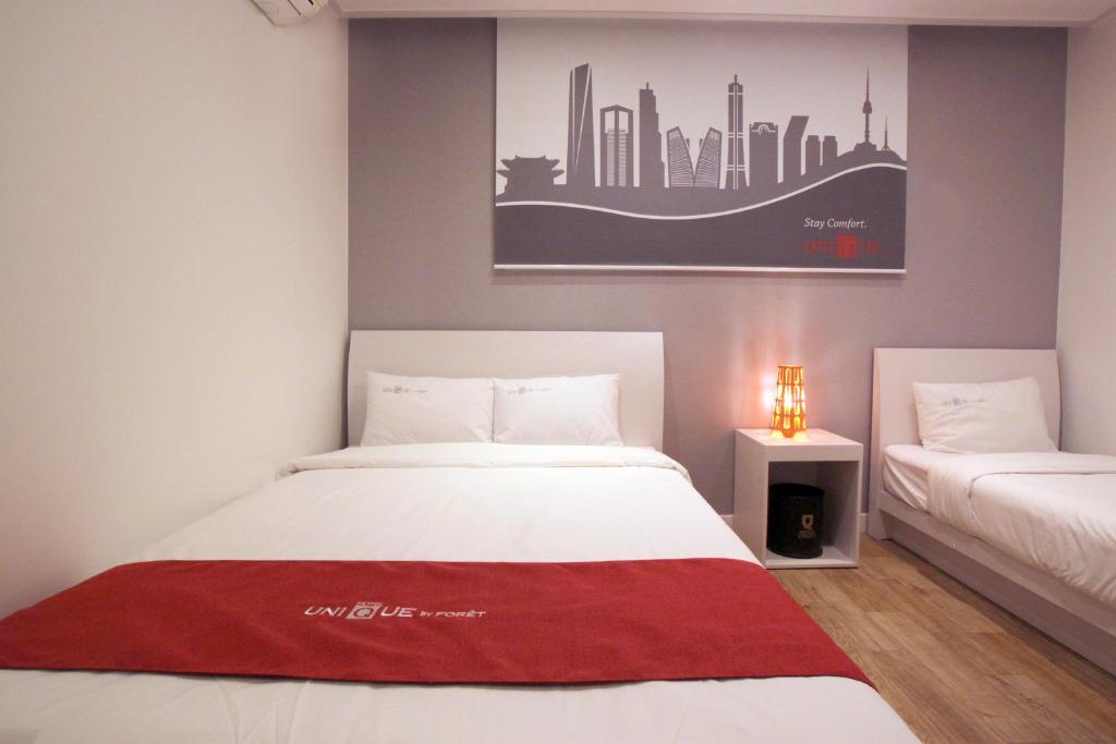 Postel nebo postele na pokoji v ubytování Jn Park Hotel Dongdaemun