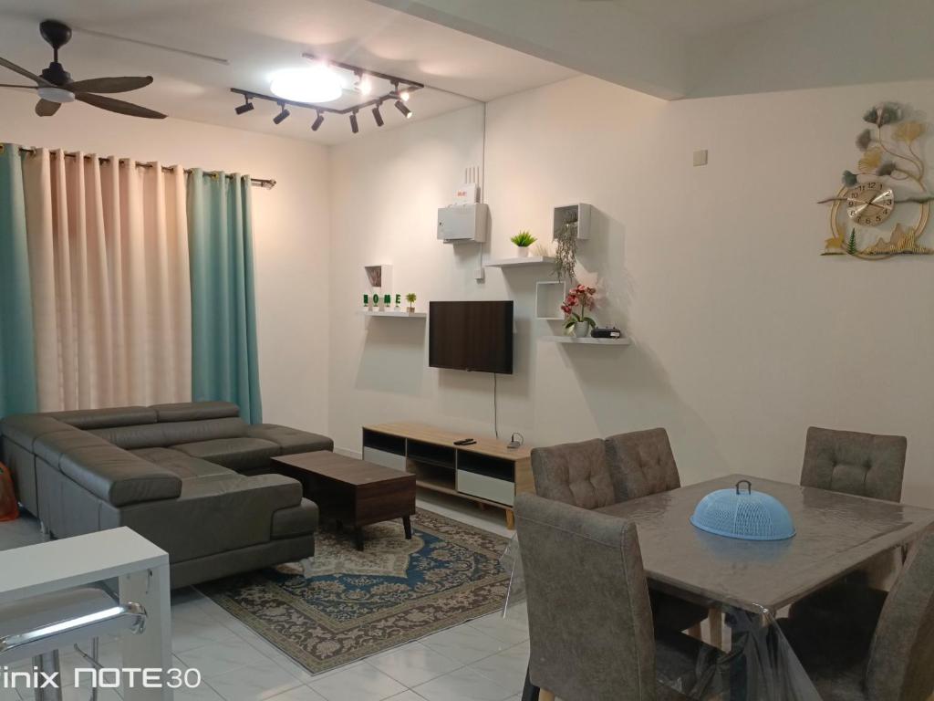 a living room with a couch and a table at DAN'S Homestay Business Suite Home in Kota Tinggi