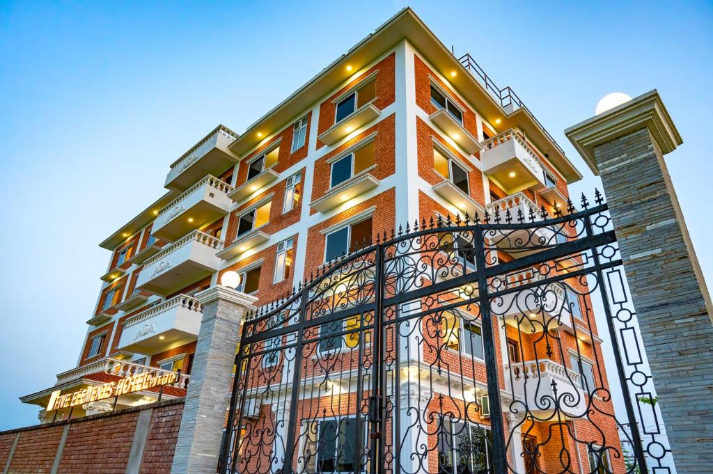 a building with an iron fence in front of it at Lumbini Five Elements Hotel in Rummindei