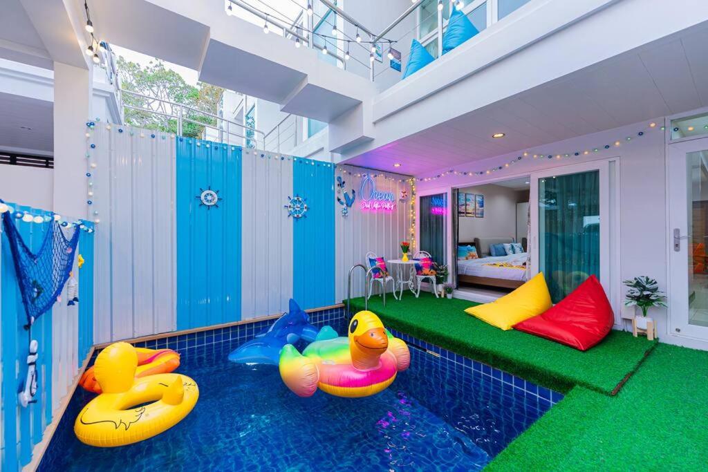 a room with a pool with two rubber ducks on the floor at Ocean Pool Villa Pattaya in Bang Sare