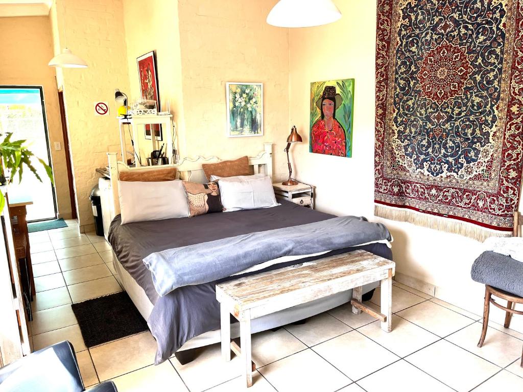 a bedroom with a bed and a rug at Lemontree in Hermanus