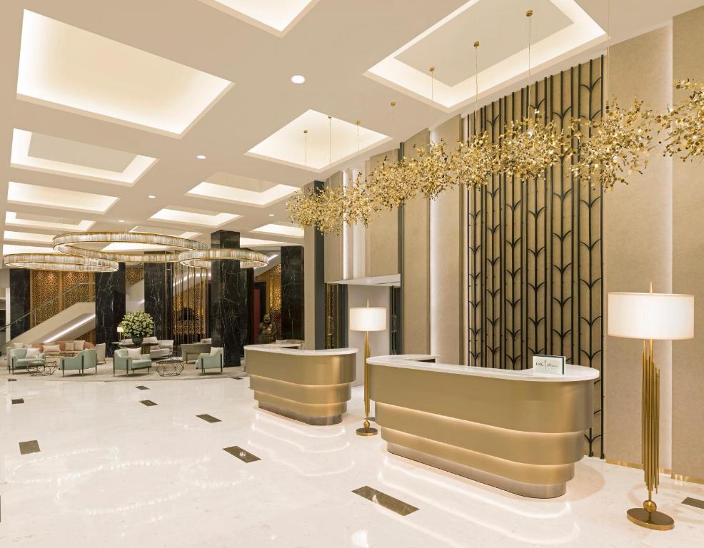 a lobby with a reception desk and chandeliers at InterContinental Jaipur Tonk Road, an IHG Hotel in Jaipur