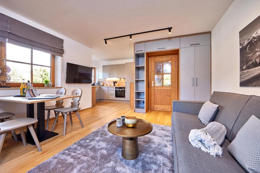 a living room with a couch and a table at Berghupferl in Garmisch-Partenkirchen