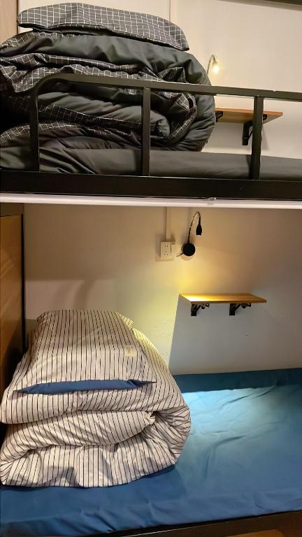 Postel nebo postele na pokoji v ubytování Banshandu Youth Hostel