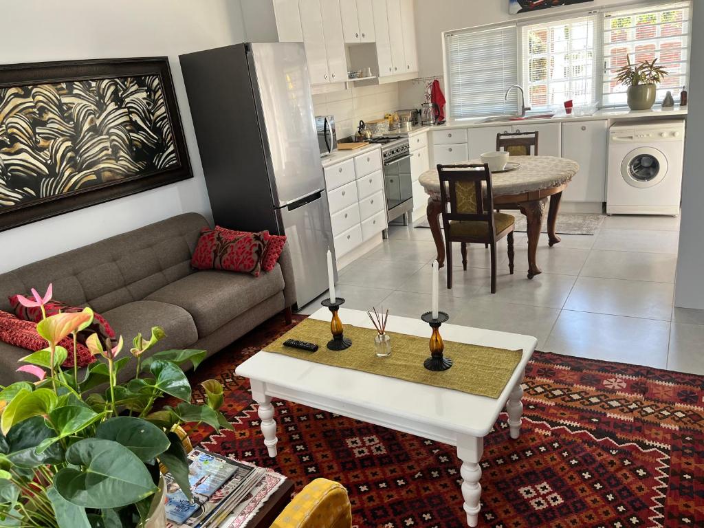 a living room with a couch and a table at Somerset West Garden Apartments 2 in Somerset West