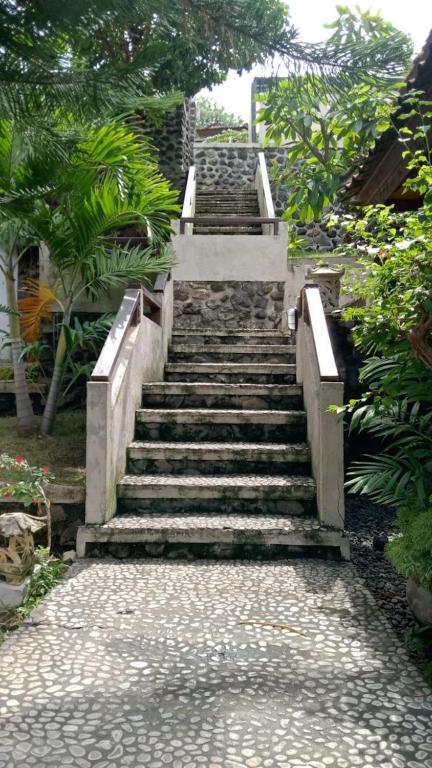 a set of stairs leading up to a building at Bali Dream House in Amed