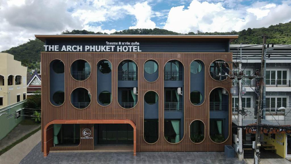 a building with a sign that reads the archued hotel at The Arch Phuket Hotel in Ban Ket Ho