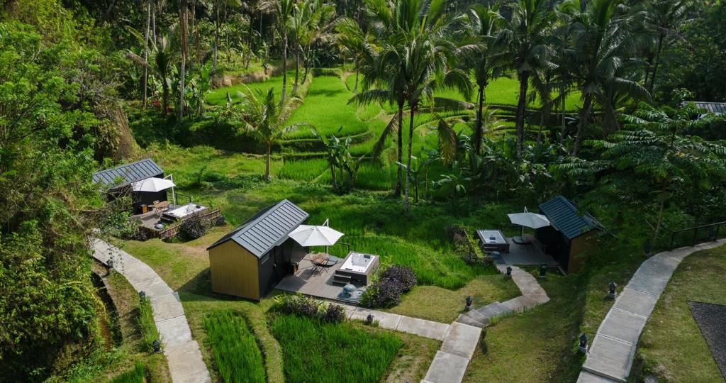 an aerial view of a garden with tables and umbrellas at Bobocabin Ubud, Bali in Tegalalang
