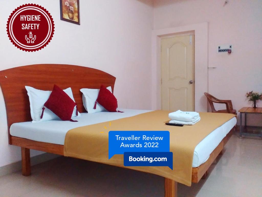 a bed in a room with a sign that reads traveler review awards at Royal Green Accommodation Chennai Airport in Chennai