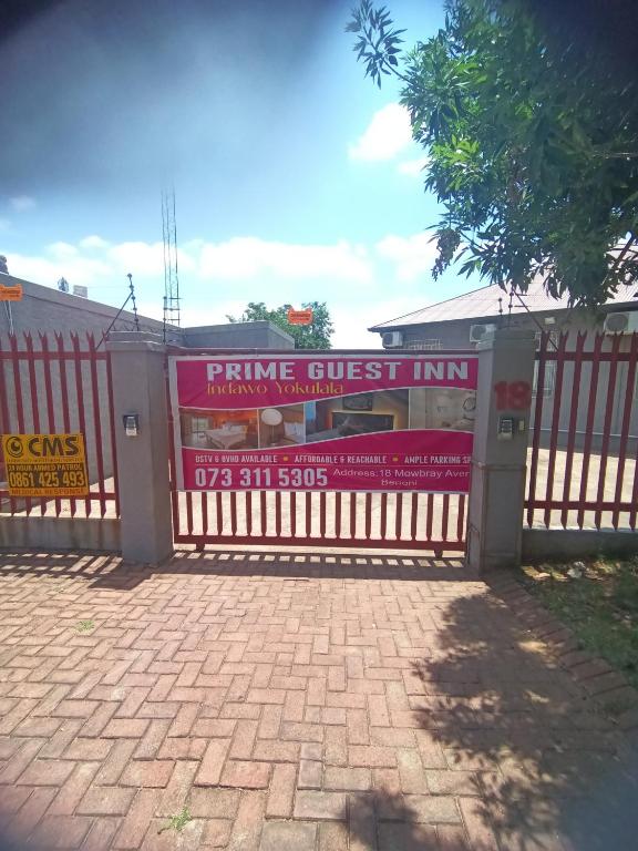 a fence with a sign that reads prime guest inn at Prime Guest Inn in Benoni