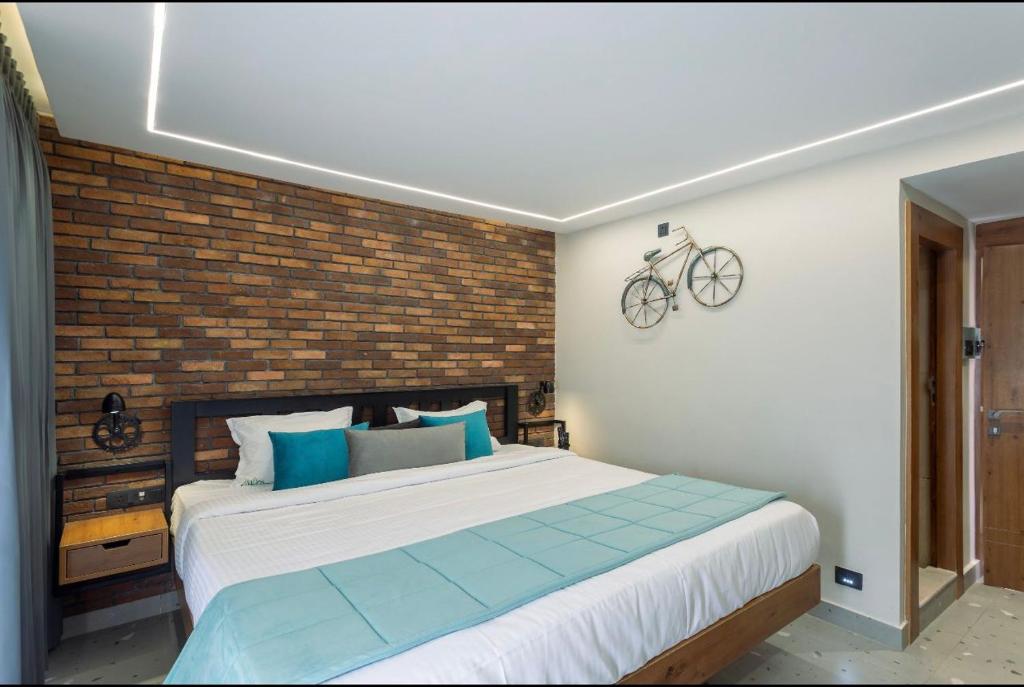 a bedroom with a large bed with a bike on the wall at Hotel Maneck Manor in Ooty
