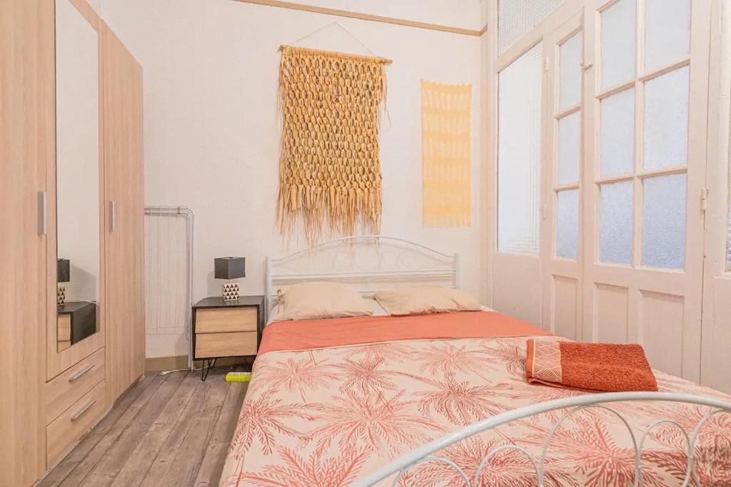 a bedroom with a bed and a dresser and window at Plage des catalans appart 4 personnes in Marseille