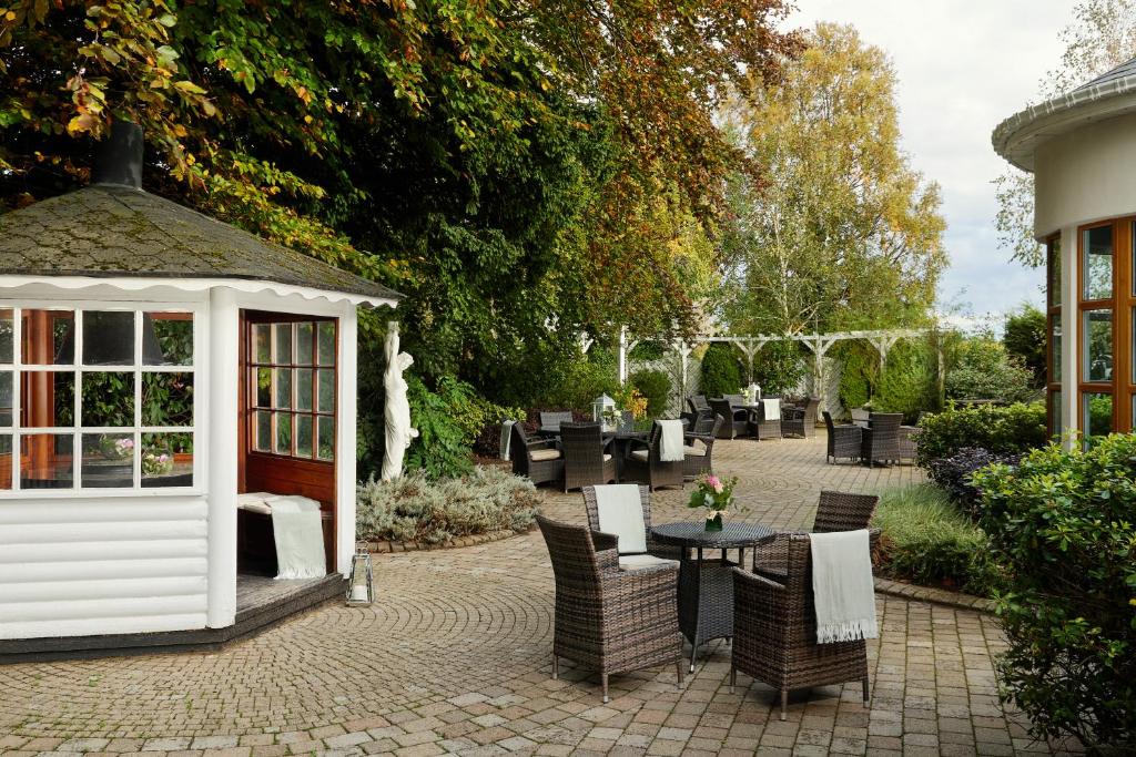 a patio with a gazebo and a table and chairs at Springfield Hotel in Leixlip