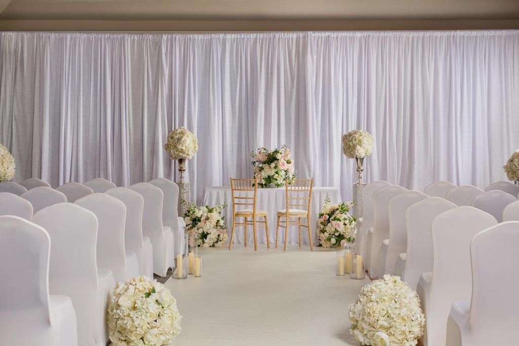 a set up for a wedding with white chairs and flowers at Springfield Hotel in Leixlip