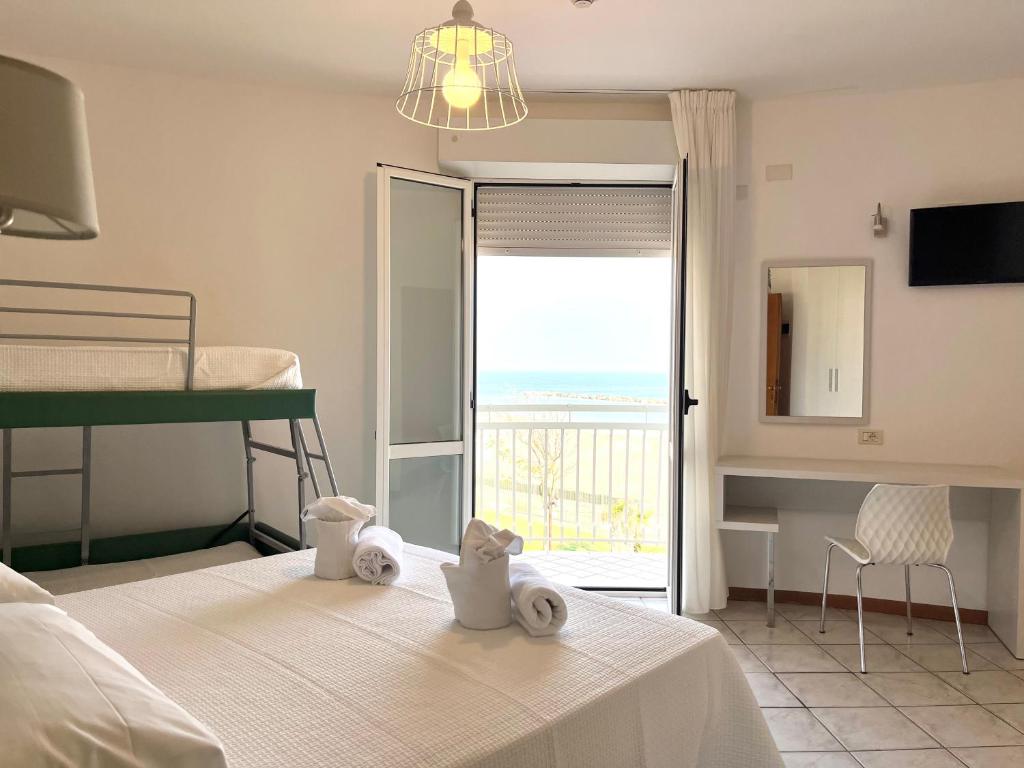 Postel nebo postele na pokoji v ubytování Hotel Acquario
