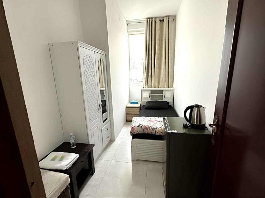アブダビにあるCorniche AD - Superb Lovely Roomのベッドと窓が備わる小さな客室です。