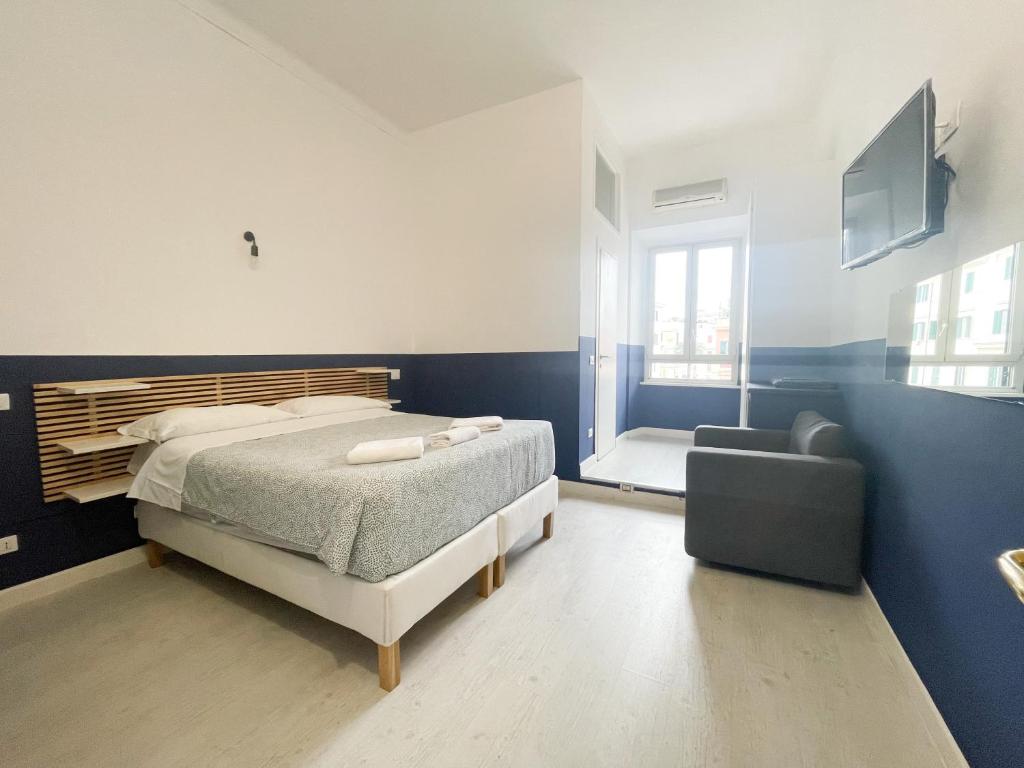 a bedroom with a bed and a couch and a television at Prati Boutique Suites in Rome