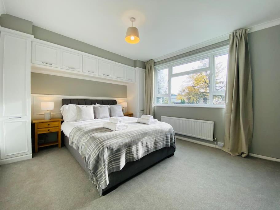 a bedroom with a large bed and a window at Stylish Apartment walk to train 