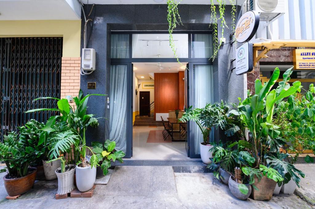 an entrance to a building with potted plants at Van Hung in Ho Chi Minh City