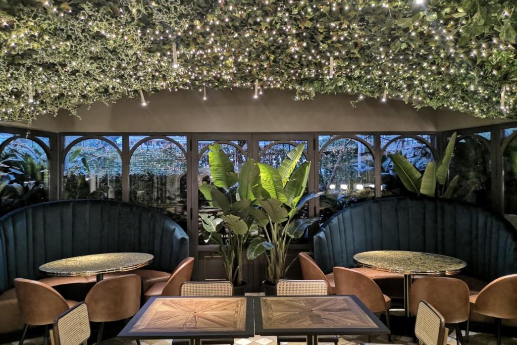 un restaurant avec des tables, des chaises et des lumières dans l'établissement Manuelina Taste Hotel, à Recco