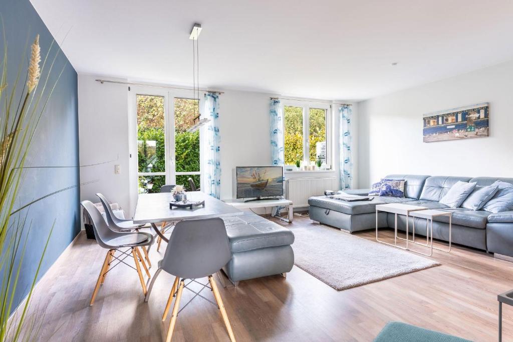 a living room with a couch and a table and chairs at Ferienhaus-Ivory-in-Binz in Binz