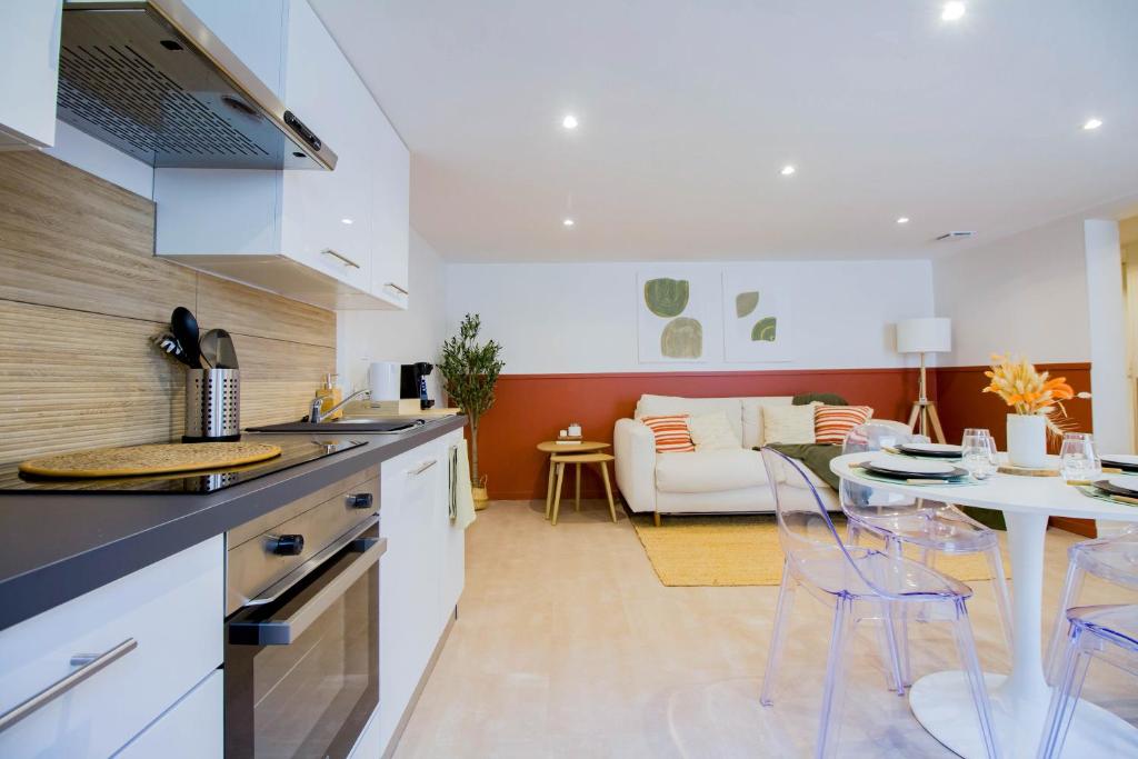 a kitchen and living room with a table and chairs at Elégante escale à Orly in Orly